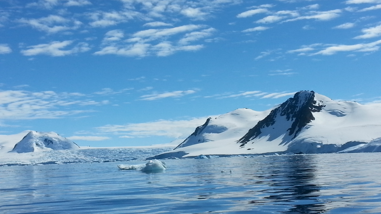 Icy waters with ice covered mountains in distance